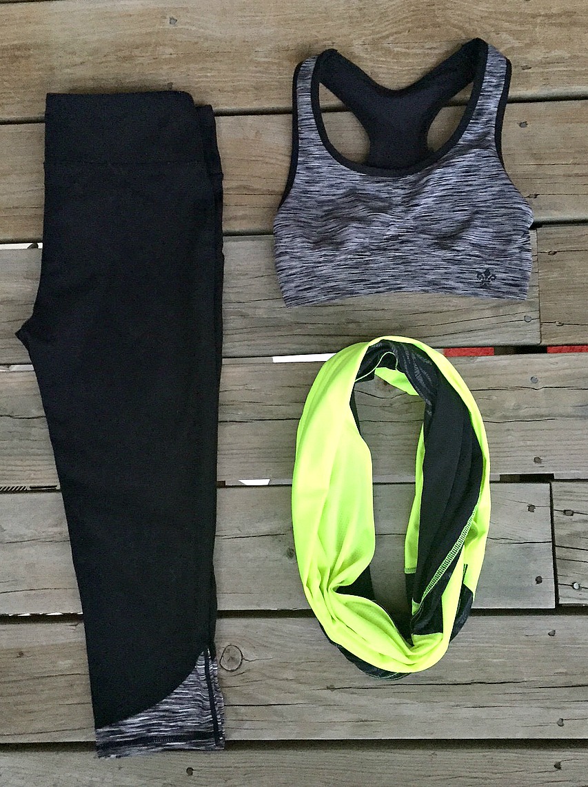 picture of black high-waisted leggings, gray sports bra and neon workout scarf 